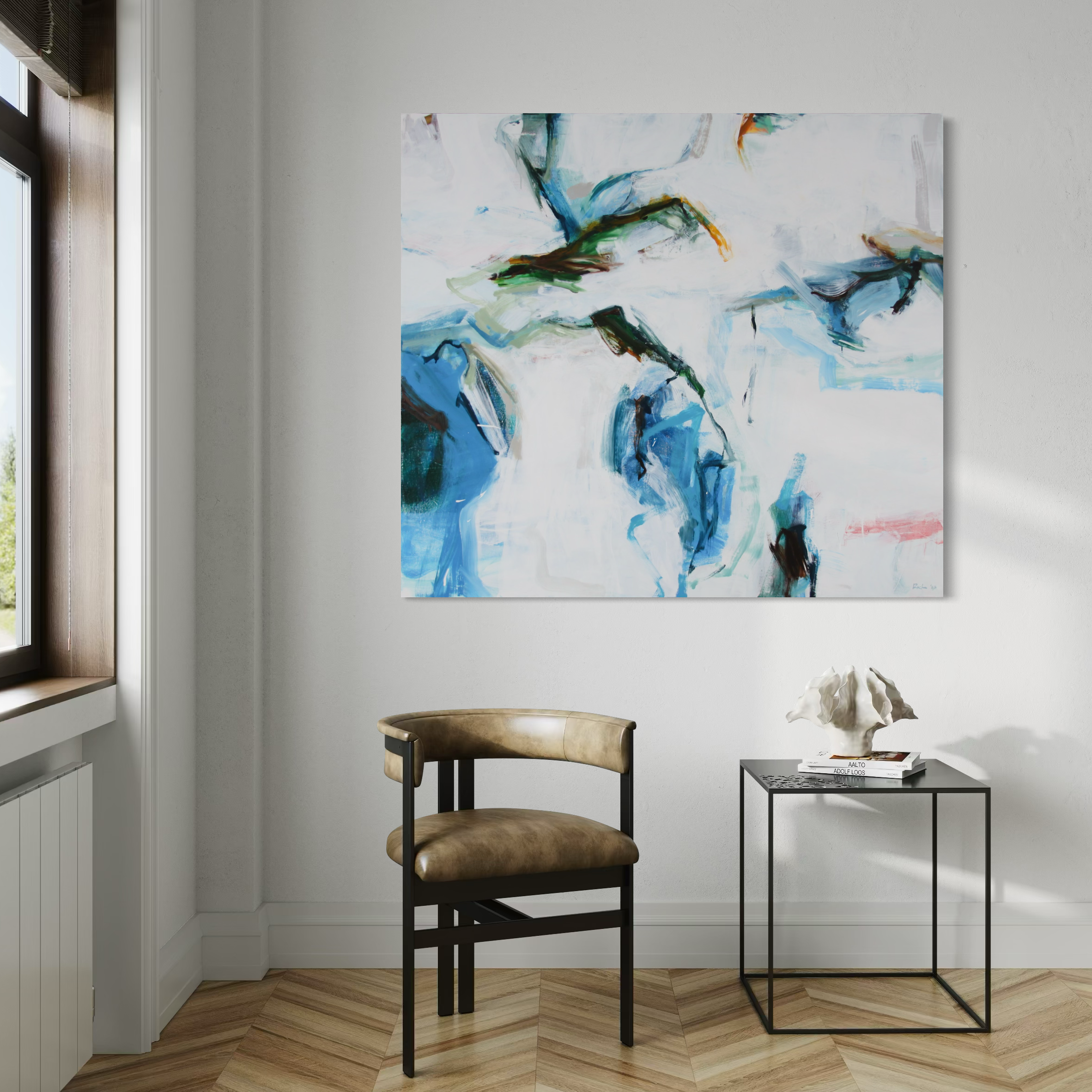 An abstract canvas wall art print featuring blue, green, and white brushstrokes, displayed in a modern room setting above a brown leather chair and a small black side table.