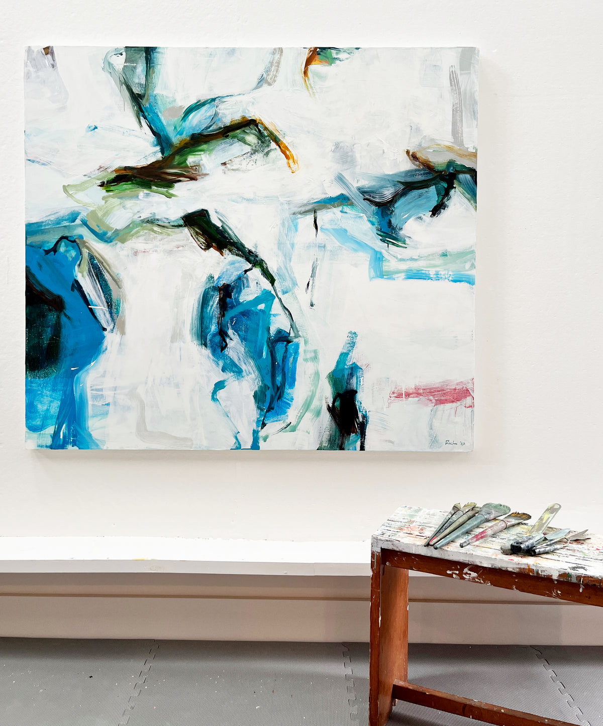 A Reach, abstract oil painting in blue, green, and white, shown in Michael Rich’s studio.