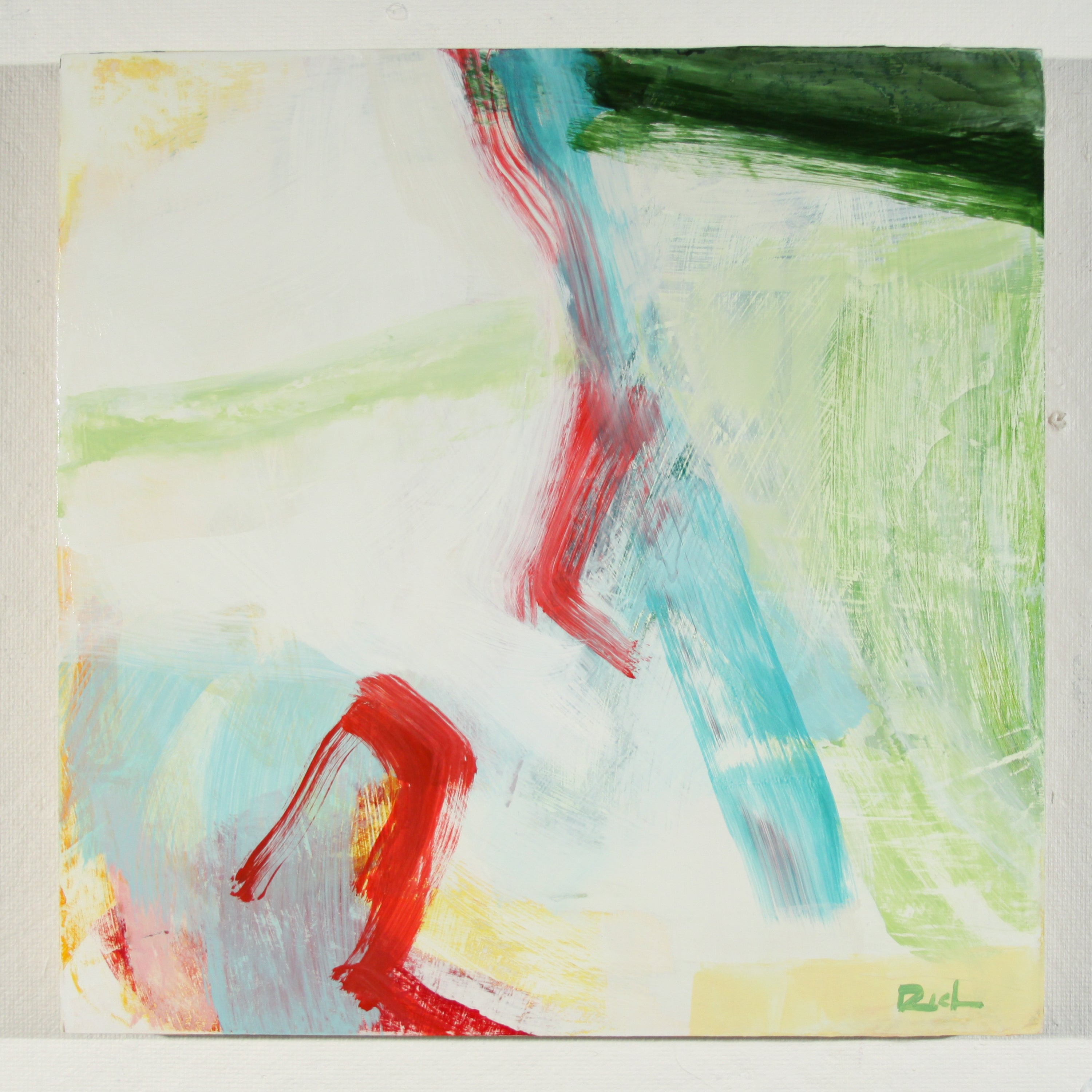 An abstract square painting featuring expressive brushstrokes in red, light blue, green, and yellow on a white background, with a small artist signature in the lower right corner.