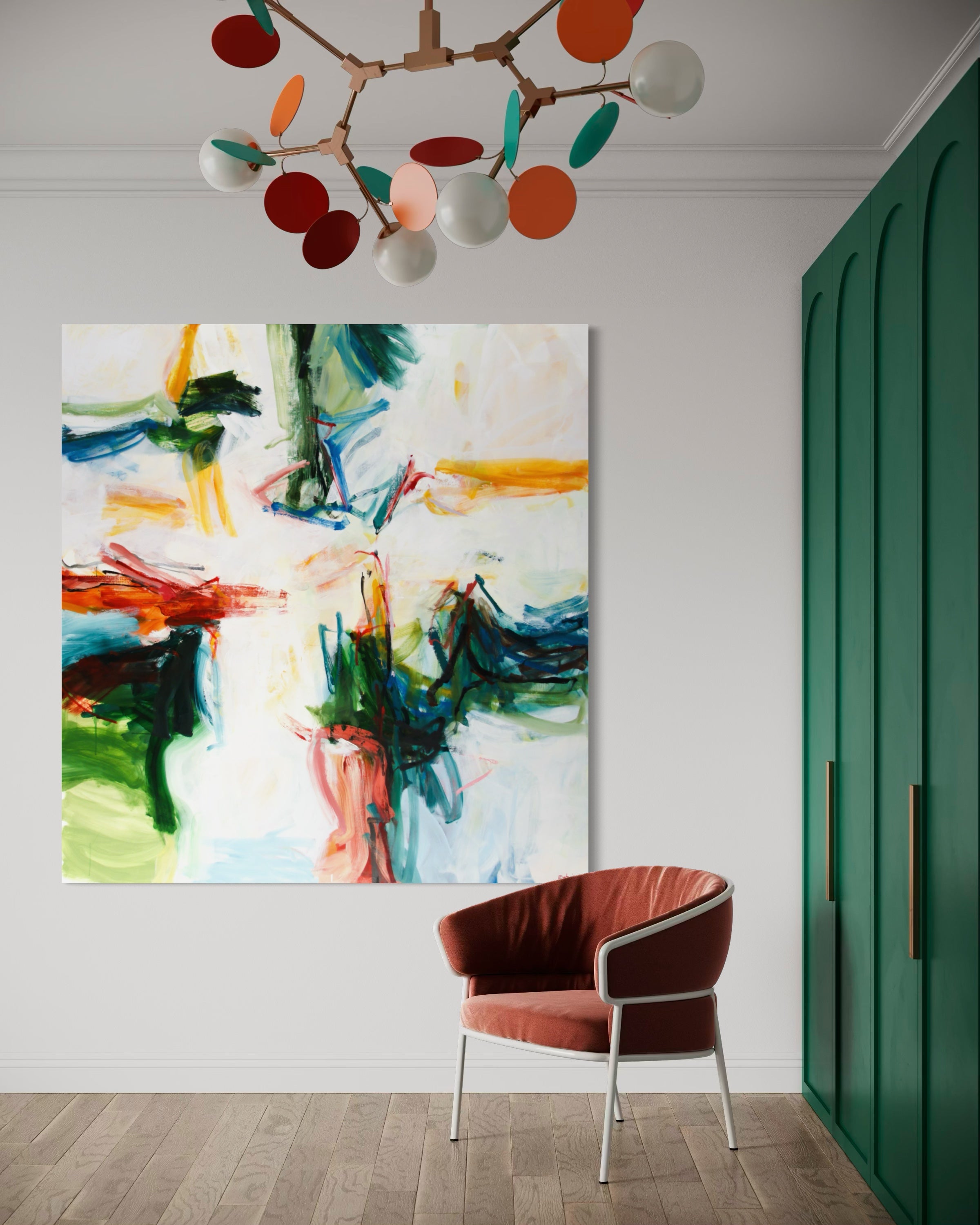 An abstract canvas painting with expressive brushstrokes in green, blue, orange, red, yellow, and white, displayed on a white wall in a modern room setting with a rust-colored armchair and a green cabinet.