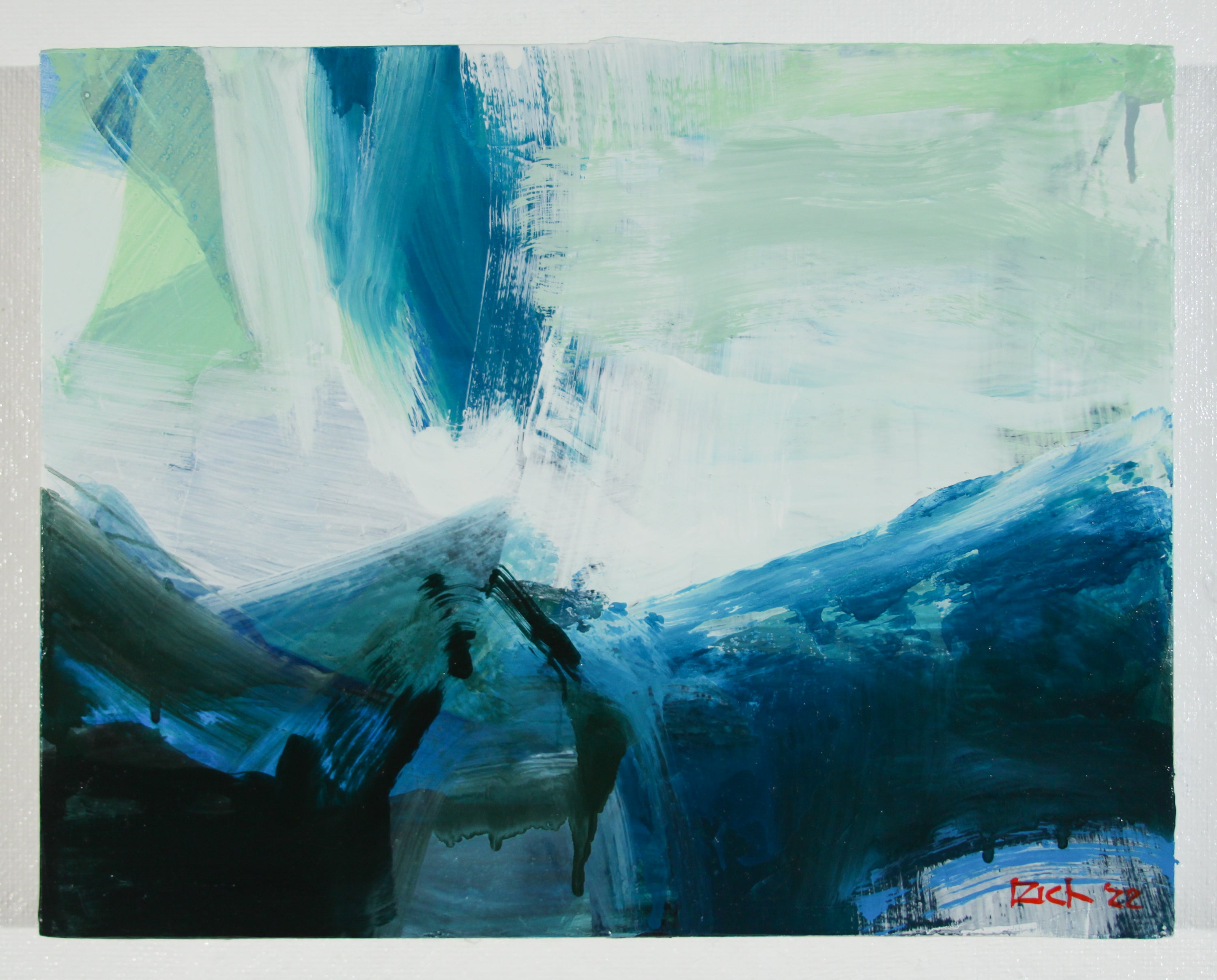 An abstract painting featuring expressive brushstrokes in shades of blue, teal, white, and light green, with dark blue and black forms at the bottom and a small red artist signature in the lower right corner.
