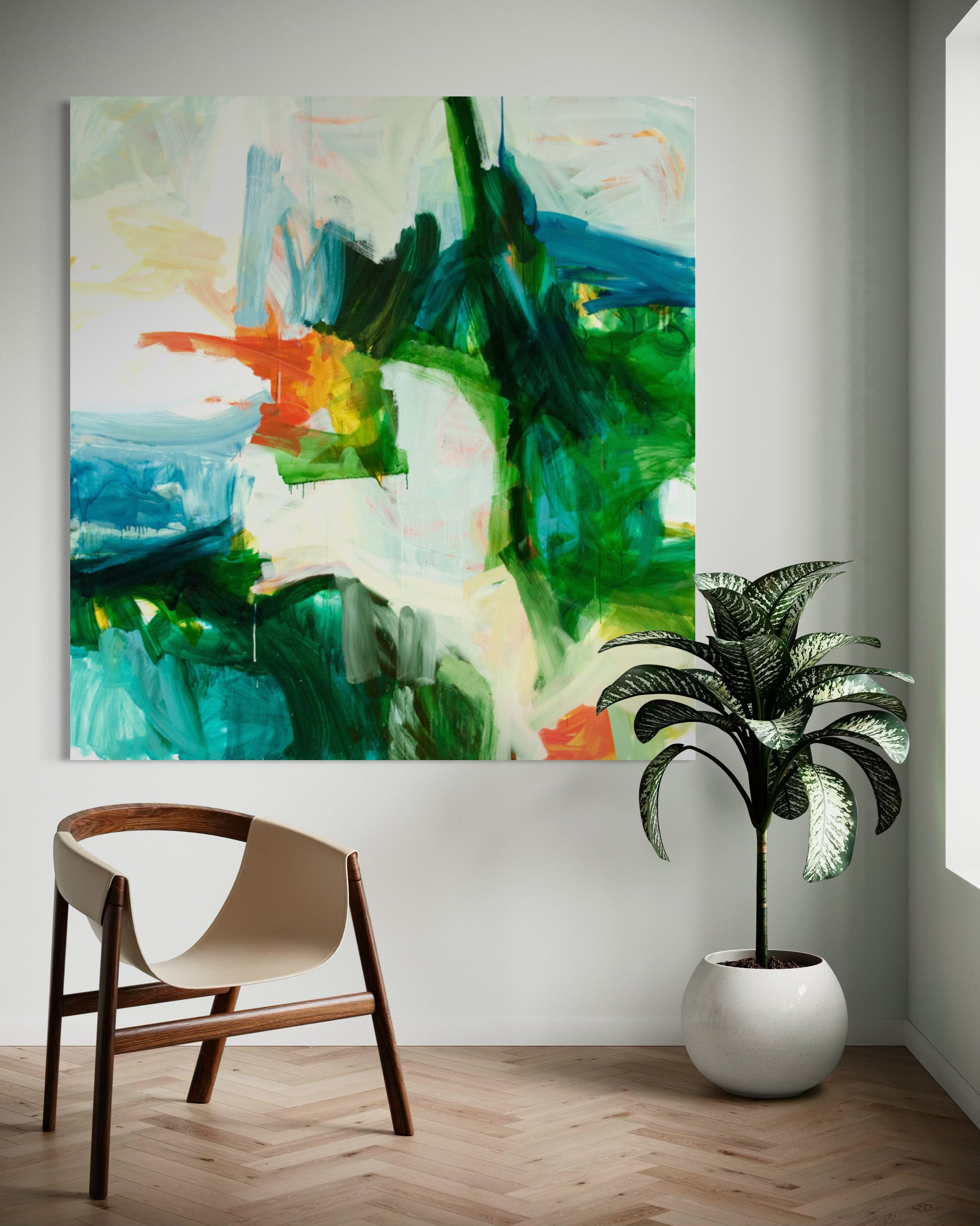 Abstract canvas wall art with green, blue, white, and orange brushstrokes, displayed in a modern room setting above a wooden chair and next to a potted plant.