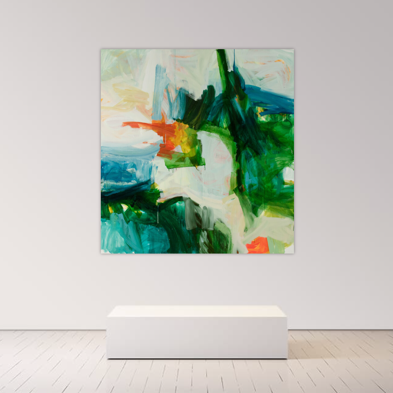 An abstract canvas painting with green, blue, teal, orange, and white brushstrokes, displayed on a light gray wall above a white pedestal in a minimalist room setting.