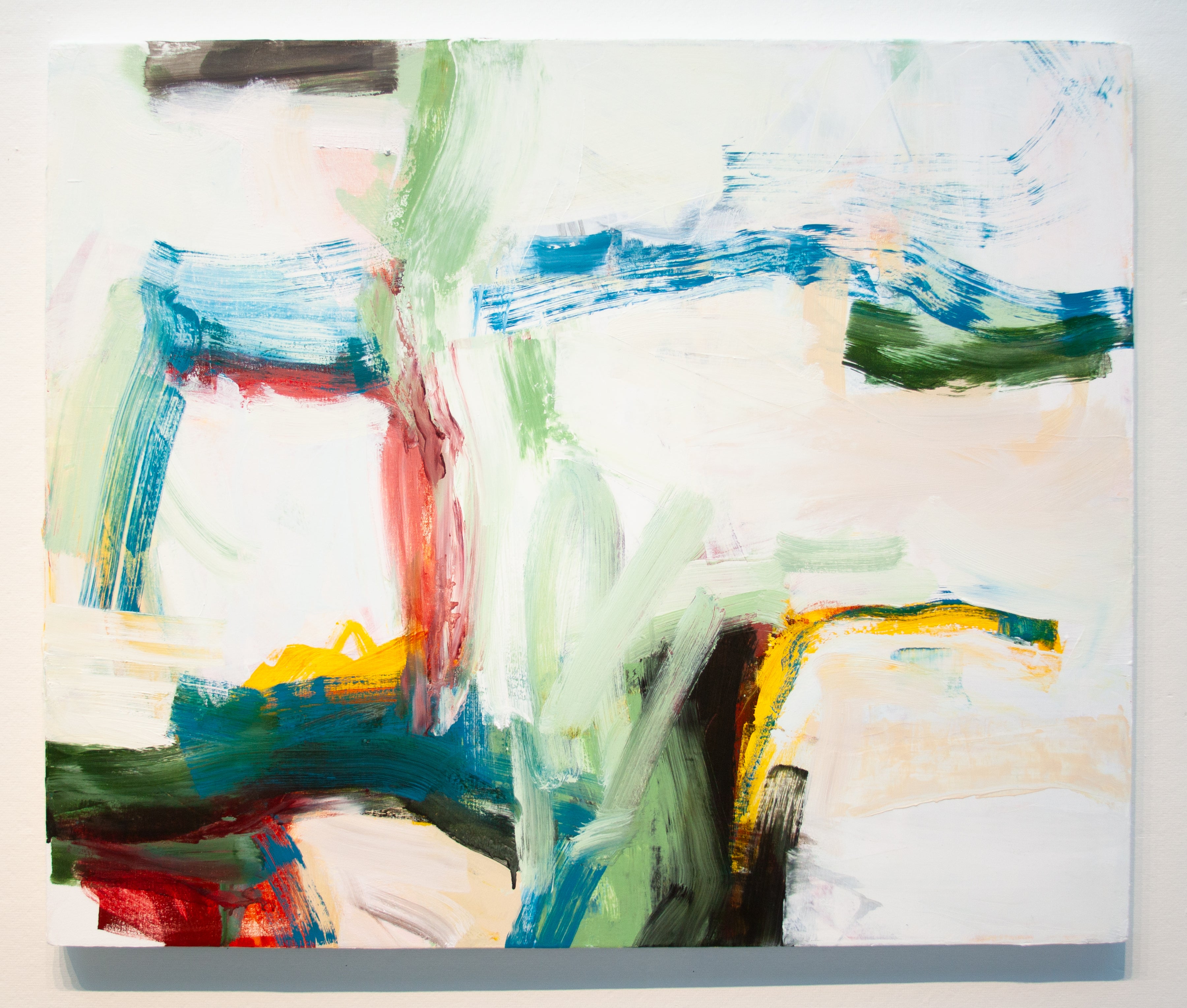 An abstract expressionist painting on a square canvas, featuring textured brushstrokes of blue, green, red, yellow, and black on a predominantly off-white background.