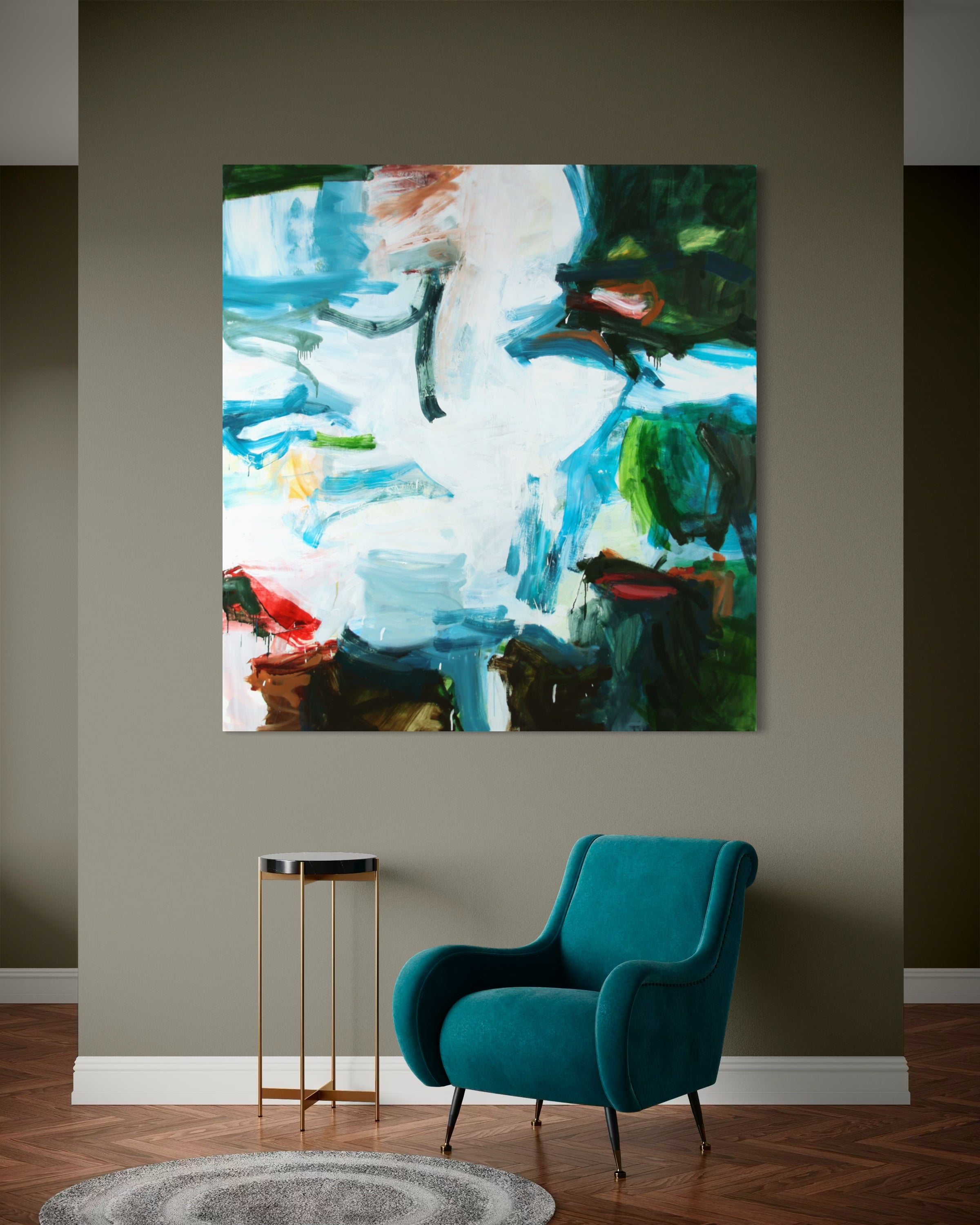An abstract canvas wall art print featuring blue, green, white, and brown brushstrokes, displayed on a dark gray wall above a teal armchair and a small side table.