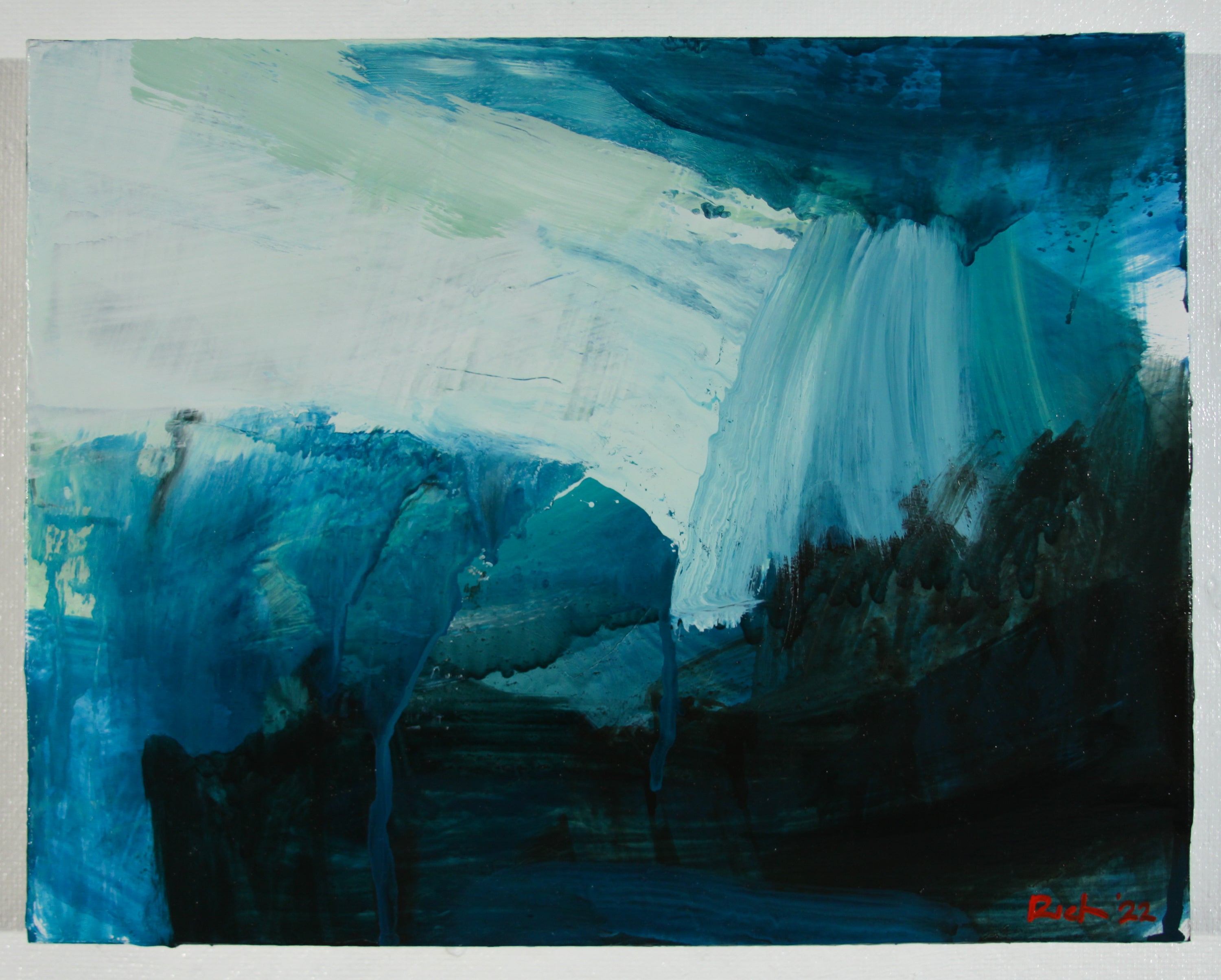 An abstract landscape painting featuring a waterfall, mountains, and trees rendered in shades of blue, teal, white, and dark navy, with a small red artist signature in the bottom right corner.