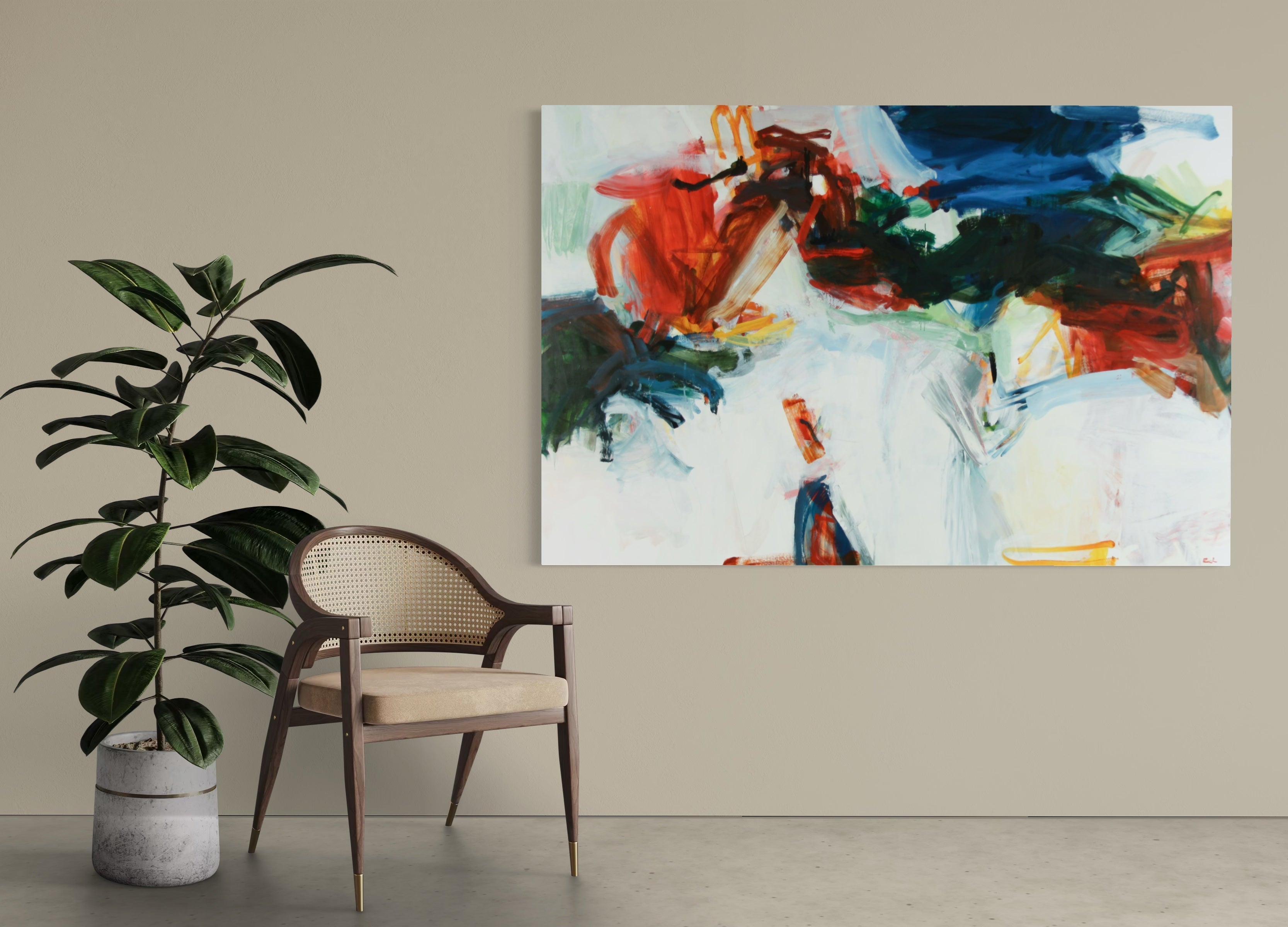 An abstract canvas wall art print featuring bold brushstrokes of red, blue, green, black, and white, displayed on a beige wall in a styled room setting next to a wooden armchair and a potted plant.