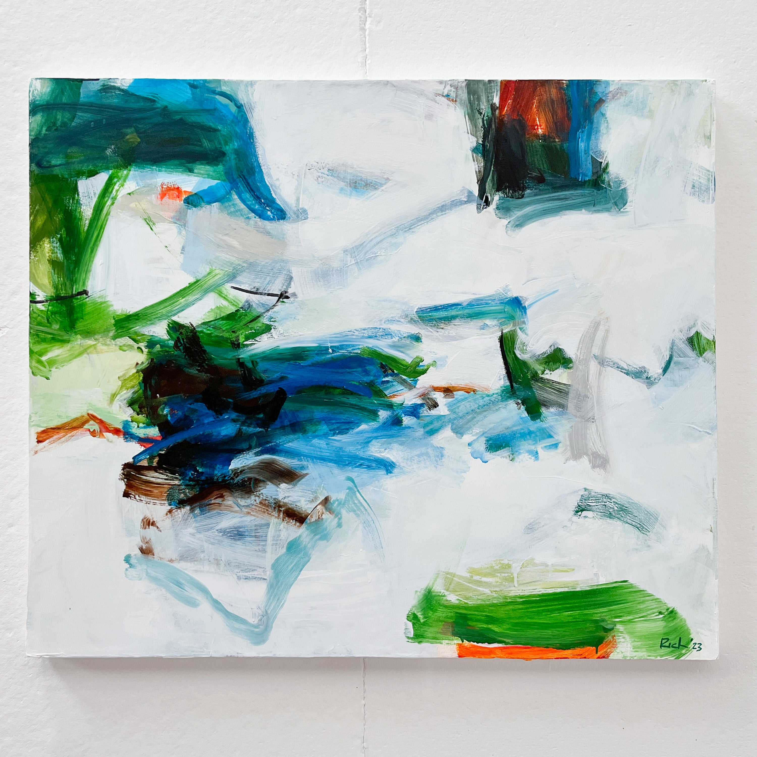 An abstract expressionist painting by Michael Rich on a white canvas featuring bold, textured brushstrokes of blue, green, black, and touches of orange and brown, hung on a white wall.