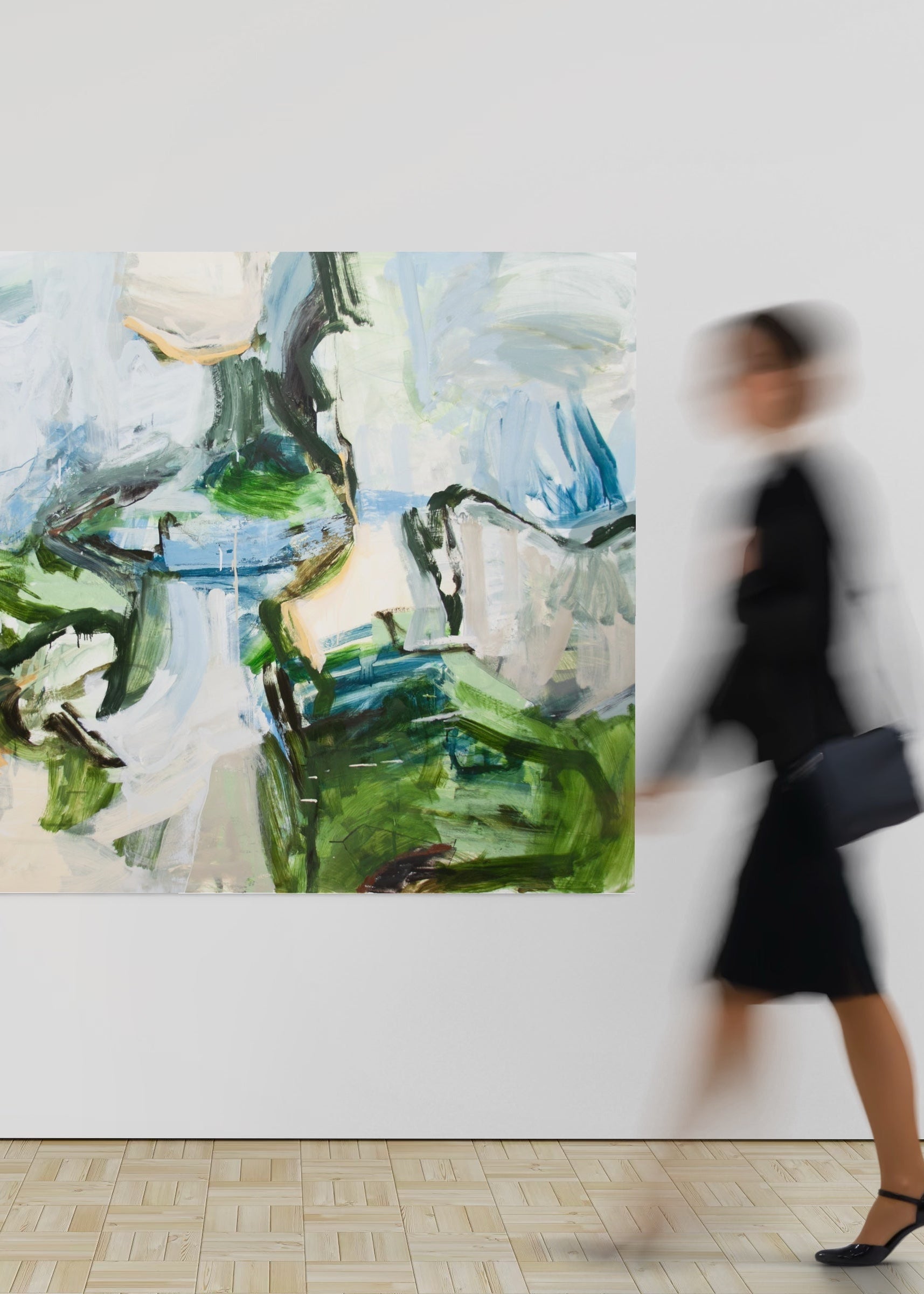 Abstract painting on a wall with a blurred person walking by